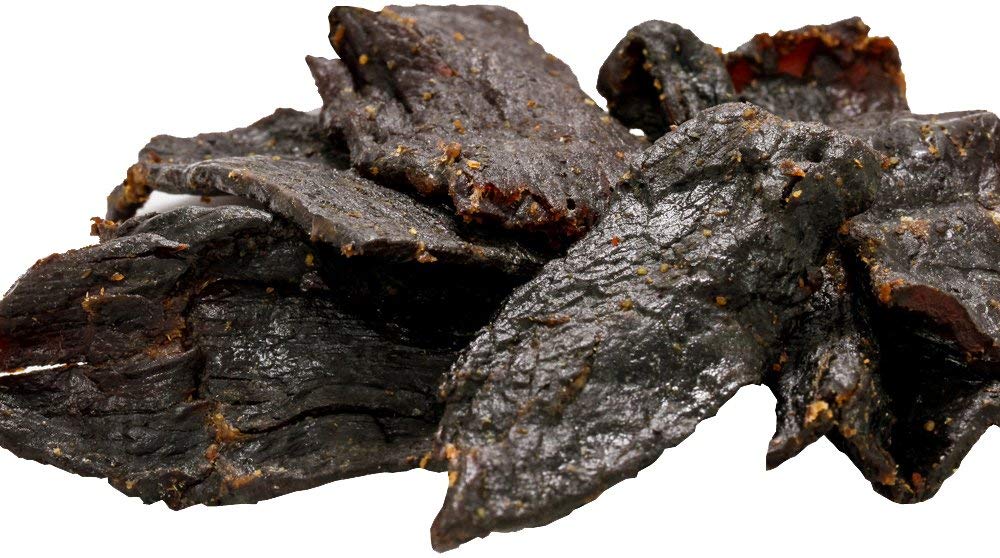 Buffalo Bills Hickory Beef Jerky piece ready to bite, ideal for travel and workouts.