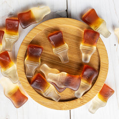 Buha Sweets cola-flavor gummy bottles for bulk party buffets.