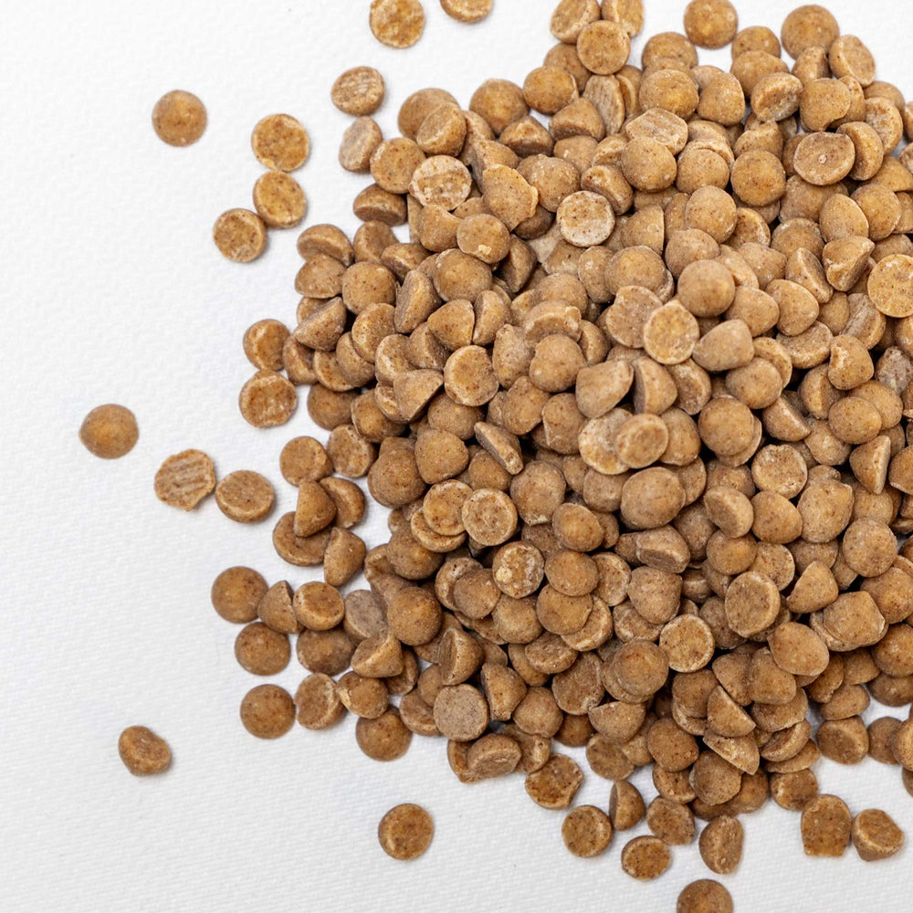 Creamy cinnamon drops on cookie dough ready for baking.