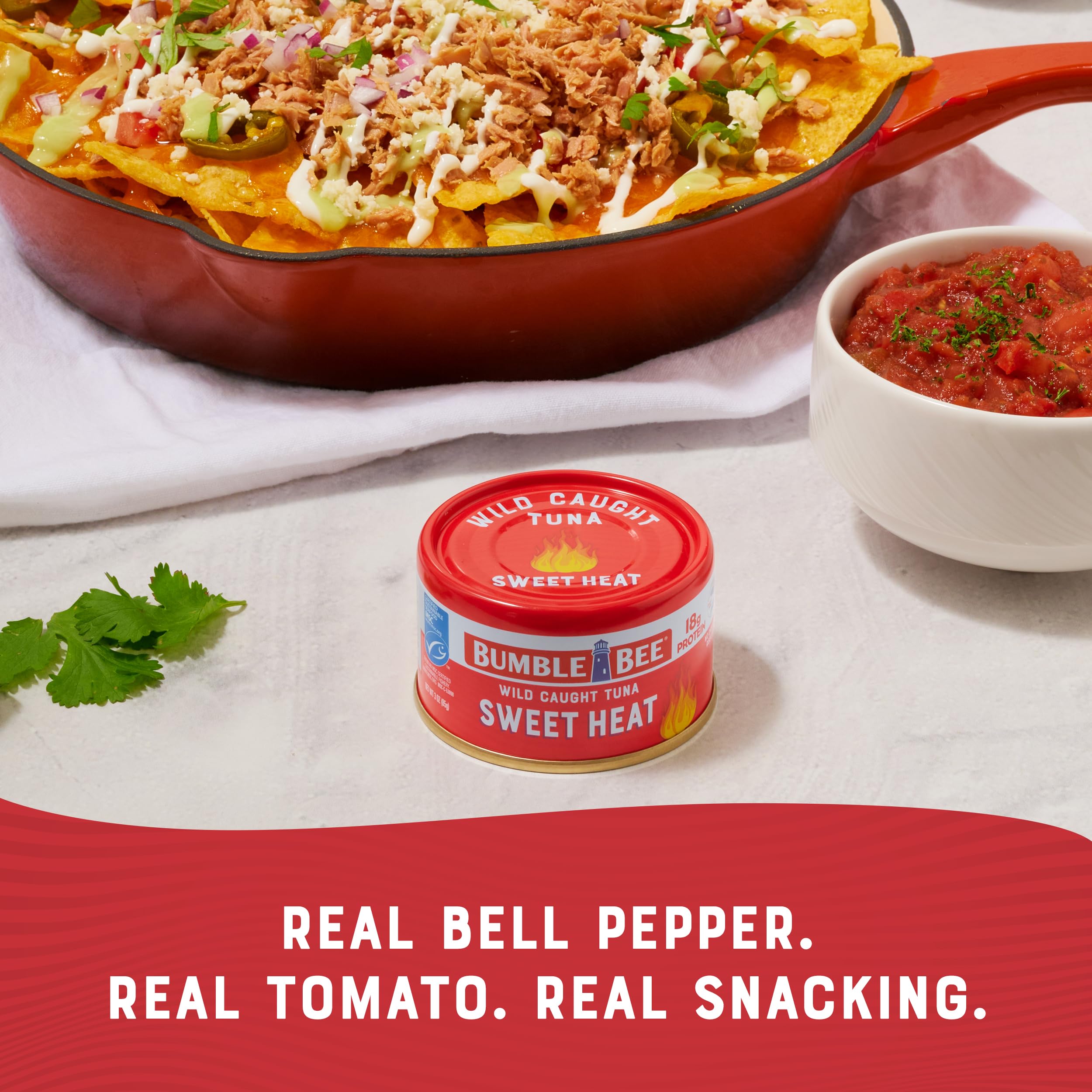 Bumble Bee Snackers Sweet Heat tuna on salad bowl shows protein-rich taste pairing.