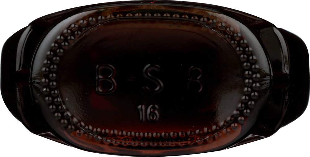 Butternut Mountain Farm Robust Dark Maple Syrup with amber hue on the counter.