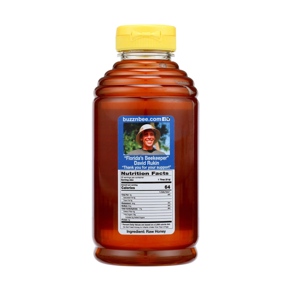 Buzzn Bee raw Florida honey closeup reveals pollen-rich natural goodness.