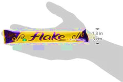 Close-up of Cadbury Flake crumbly chocolate texture, highlighting delicate strands.