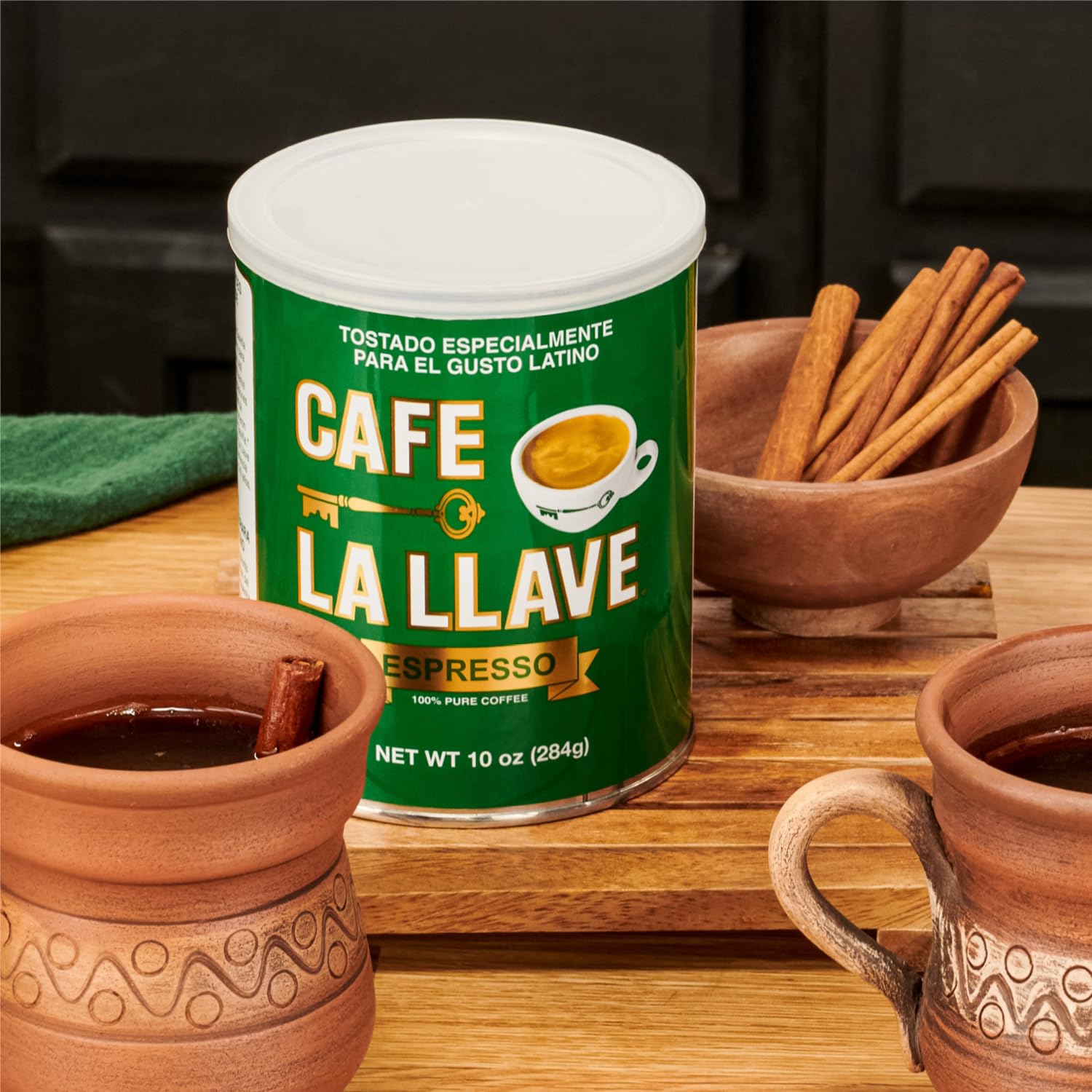 Close-up of Cafe La Llave dark roast coffee showing deep color and grind readiness.