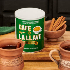 Close-up of Cafe La Llave dark roast coffee showing deep color and grind readiness.
