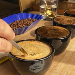 Aromas rise from Cafe Quindio Excelso ground coffee in a pour-over setup