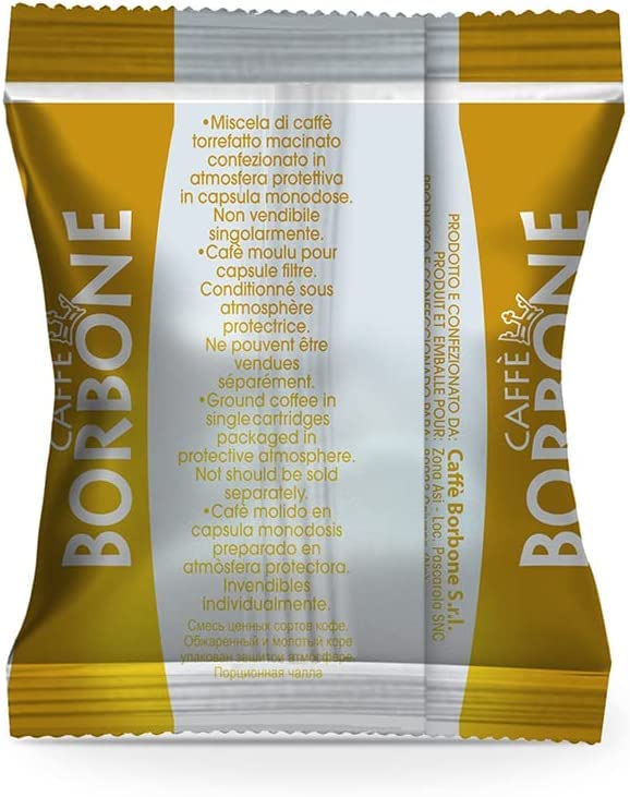 Caffè Borbone Respresso Gold capsules beside a prepared espresso shot