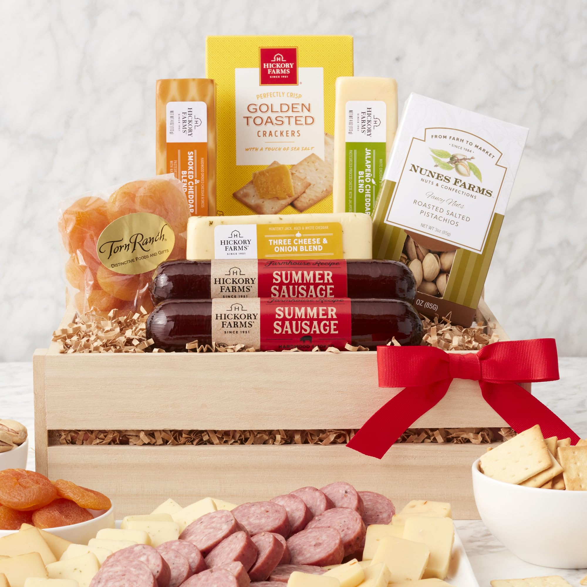 California Delicious gourmet snacks assortment with nuts, fruit, cheeses, and crackers, ideal for entertaining.