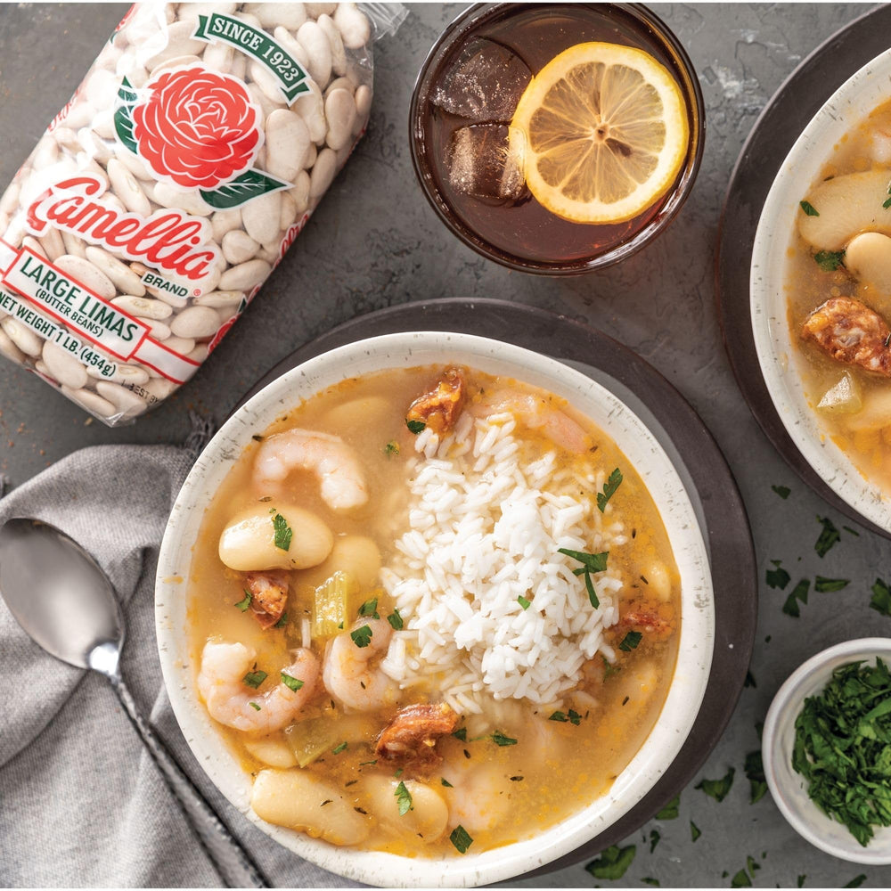 Creamy spoonfuls of Camellia Brand butter beans in a bowl, perfect for stews.