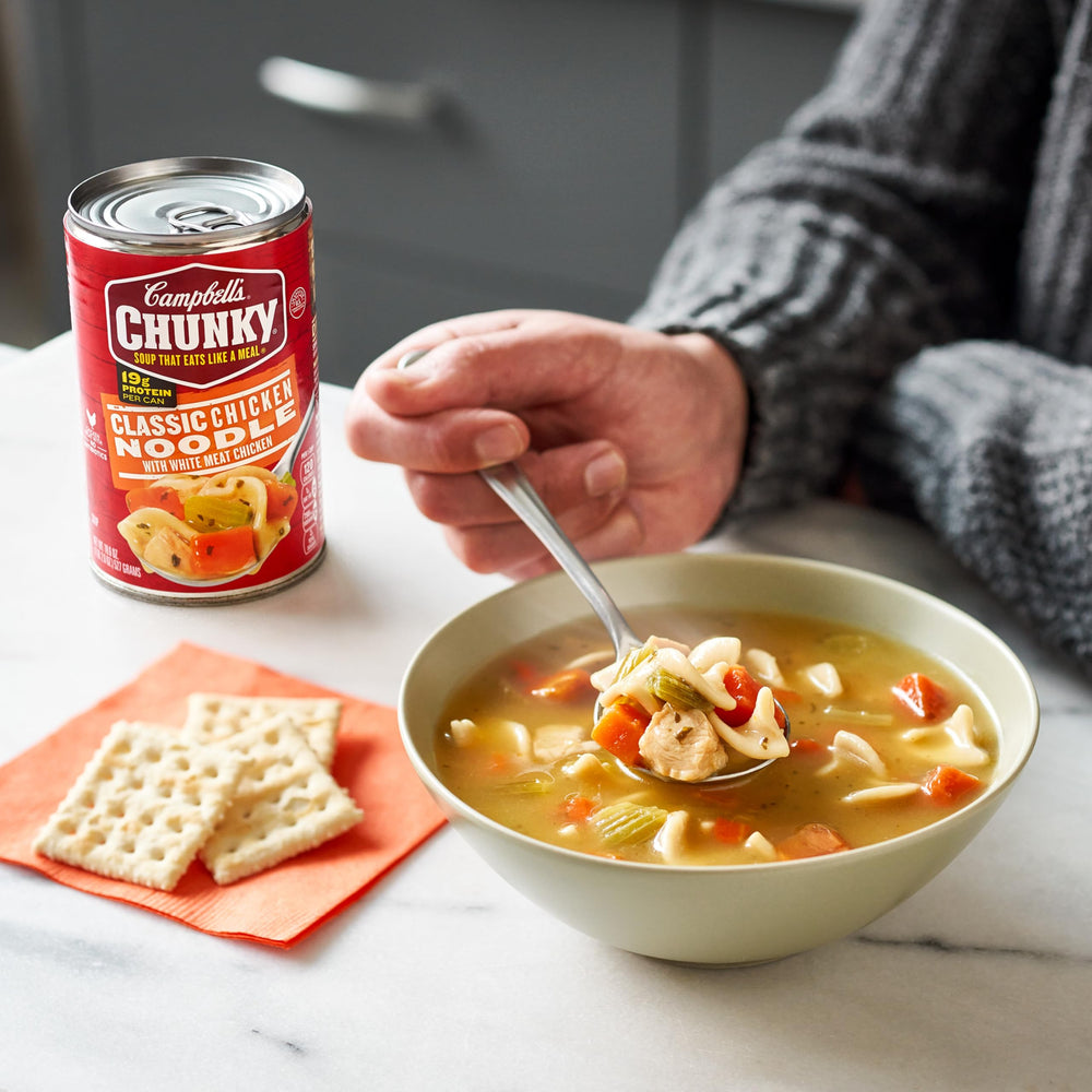 Microwave-ready Campbell's Chunky Classic Chicken Noodle Soup being heated