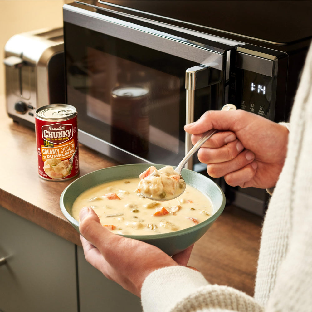 Campbell's Chunky Creamy Chicken and Dumplings microwaving in a bowl demonstrates quick prep.