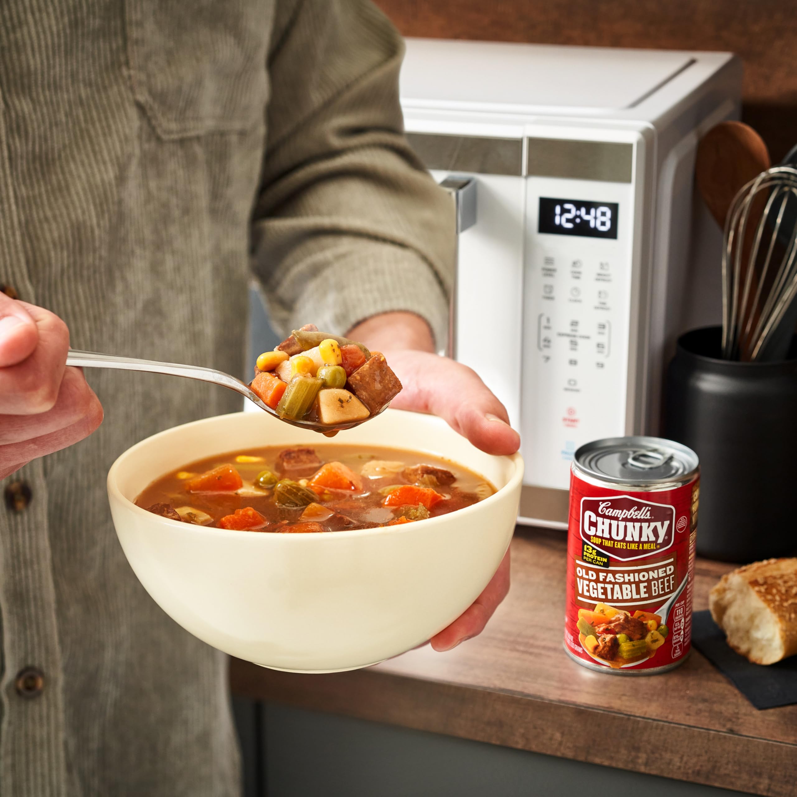Campbell's Chunky Old Fashioned Vegetable Beef Soup warming over a campfire for outdoorsy meals.