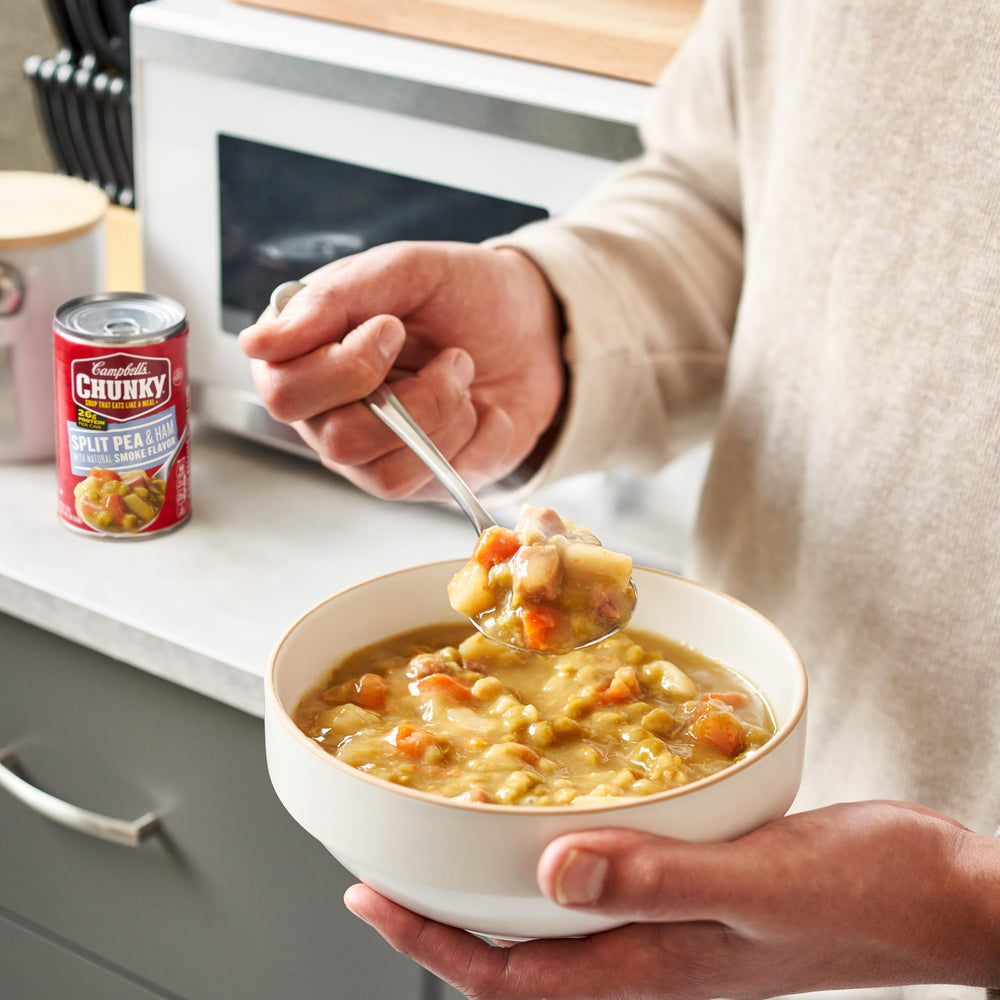 Campbell's Chunky Split Pea Soup with Ham potatoes and carrots visible in the broth for heartiness.