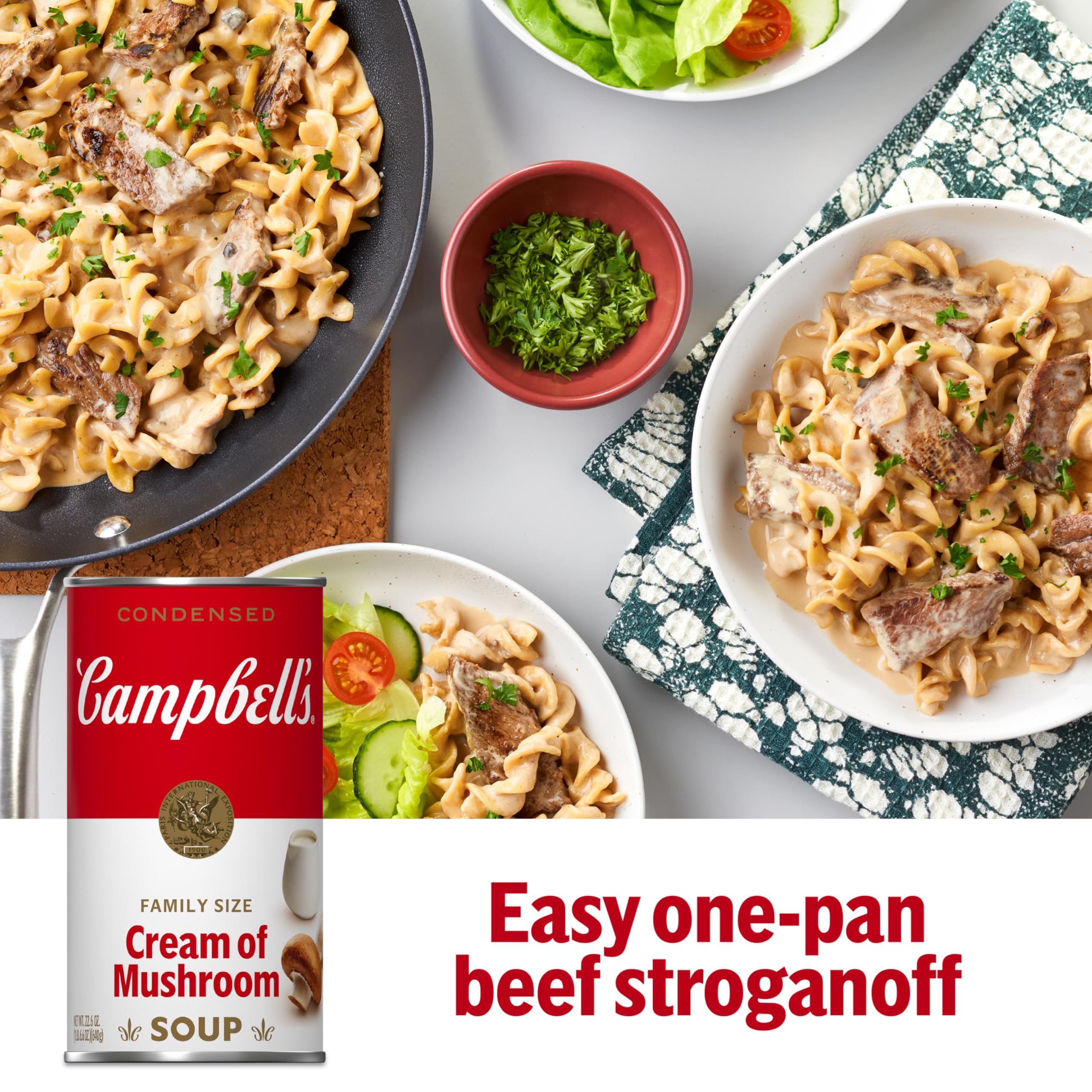 Campbell's Cream of Mushroom Soup on the stove with whisk, starting a creamy sauce.