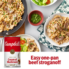 Campbell's Cream of Mushroom Soup on the stove with whisk, starting a creamy sauce.