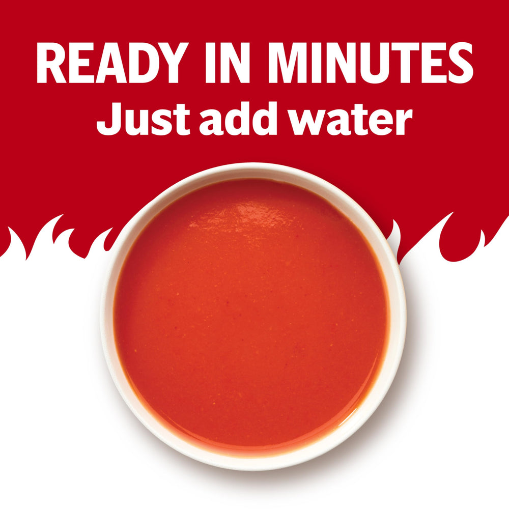 Steaming bowl of Campbell's Spicy Tomato Soup ready for a quick dinner.