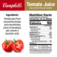 Campbell's tomato juice poured into a glass with lime for a refreshing drink.
