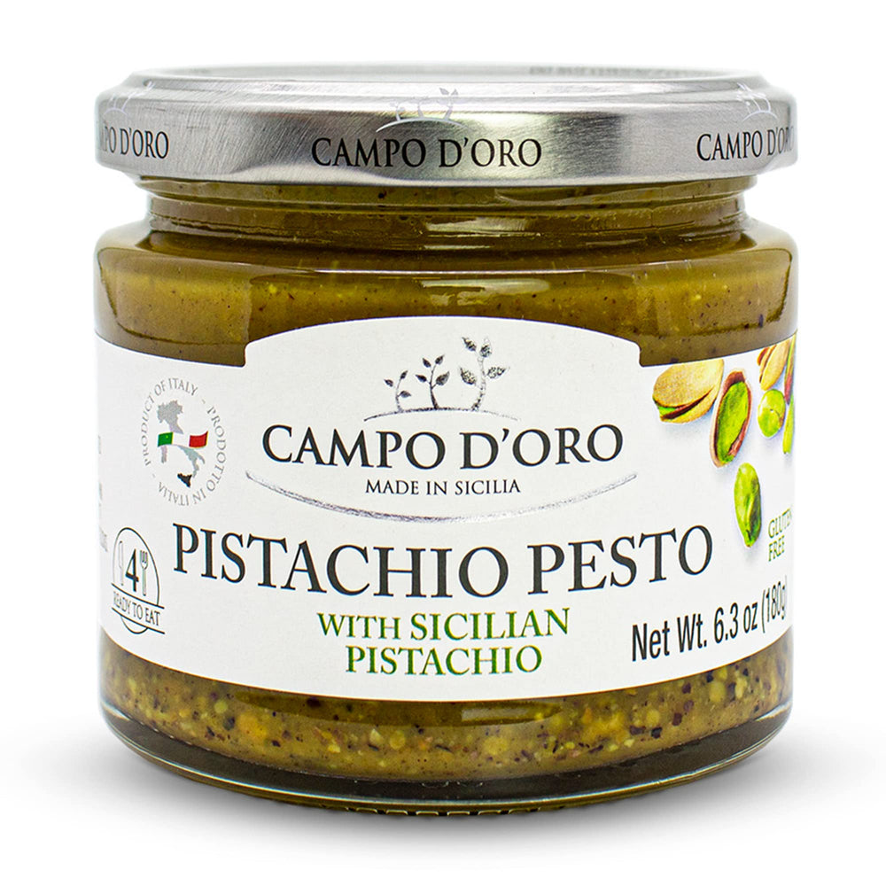 Campo D'Oro Pistachio Pesto Paste jar ready for spreading on crusty bread.