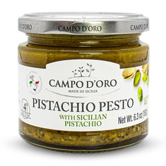 Campo D'Oro Pistachio Pesto Paste jar ready for spreading on crusty bread.
