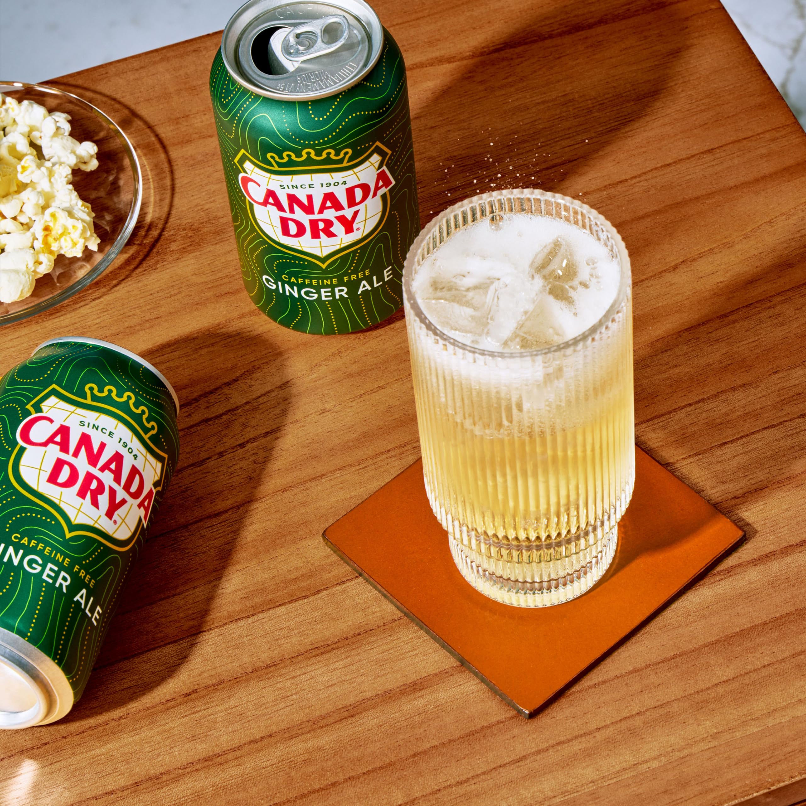Canada Dry Ginger Ale can being poured into a copper mug for Moscow Mule.