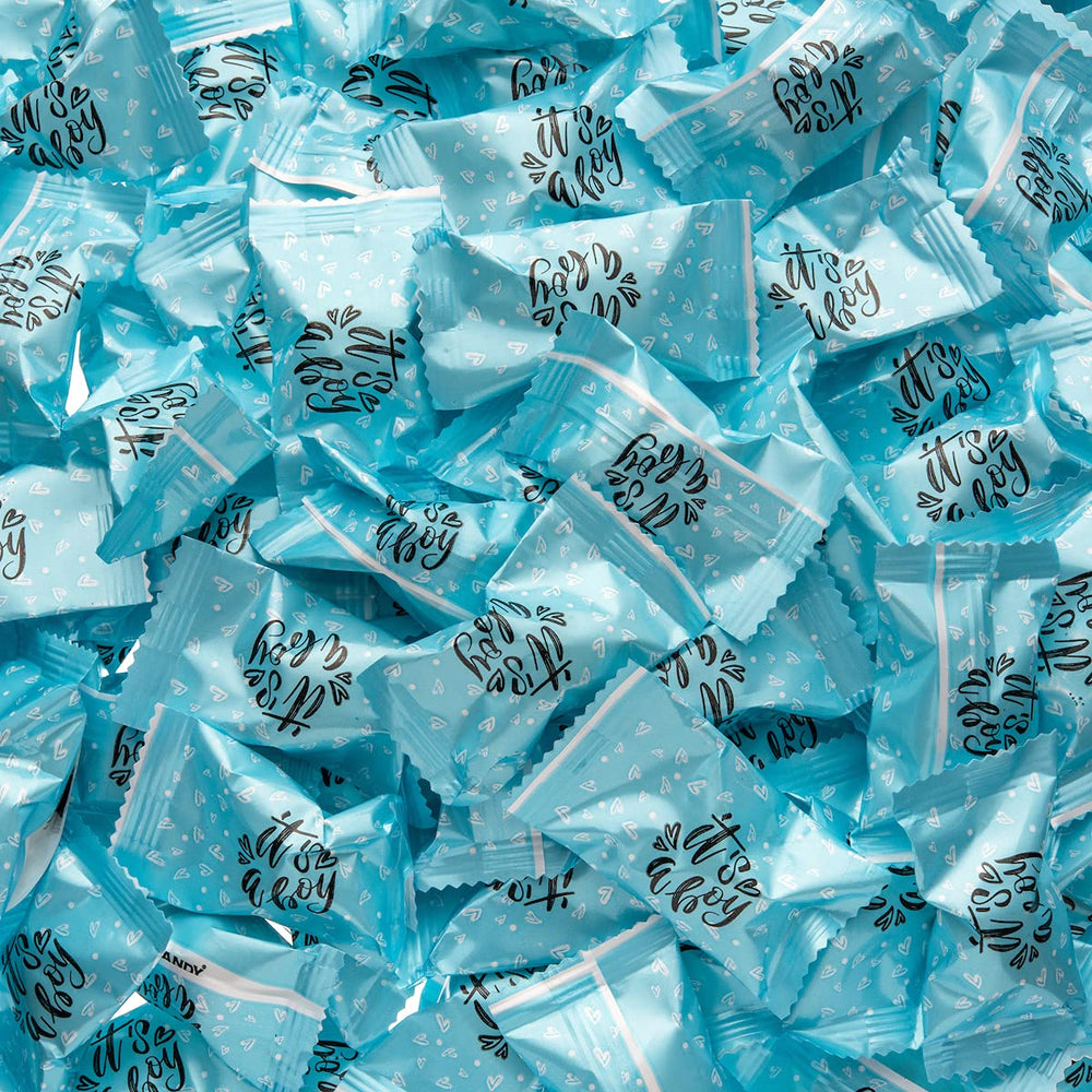 Candy Envy Baby shower favors display enhances table with blue accents.