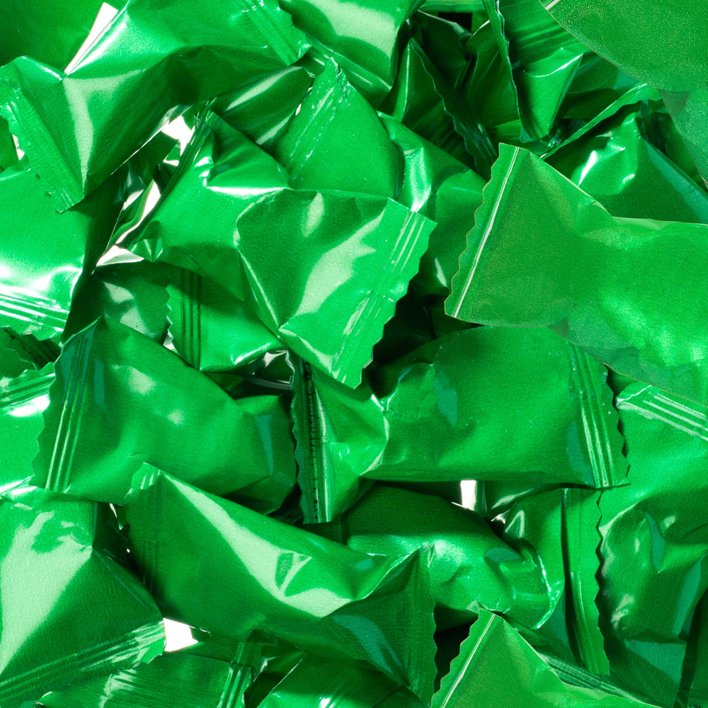 Bag of Candy Envy green-wrapped buttermints on a table at an event