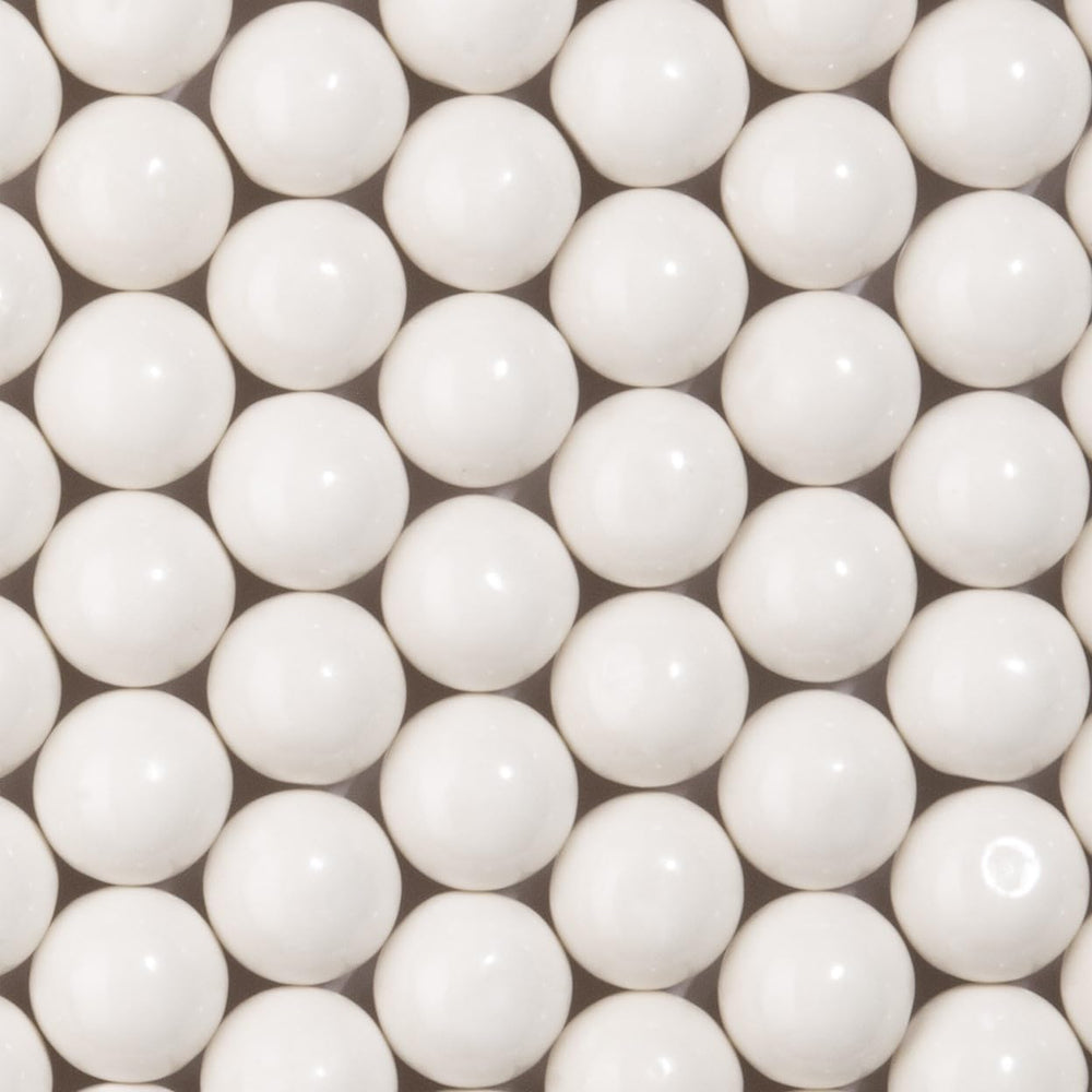 Close up view of Candy Envy white gumballs glossy texture