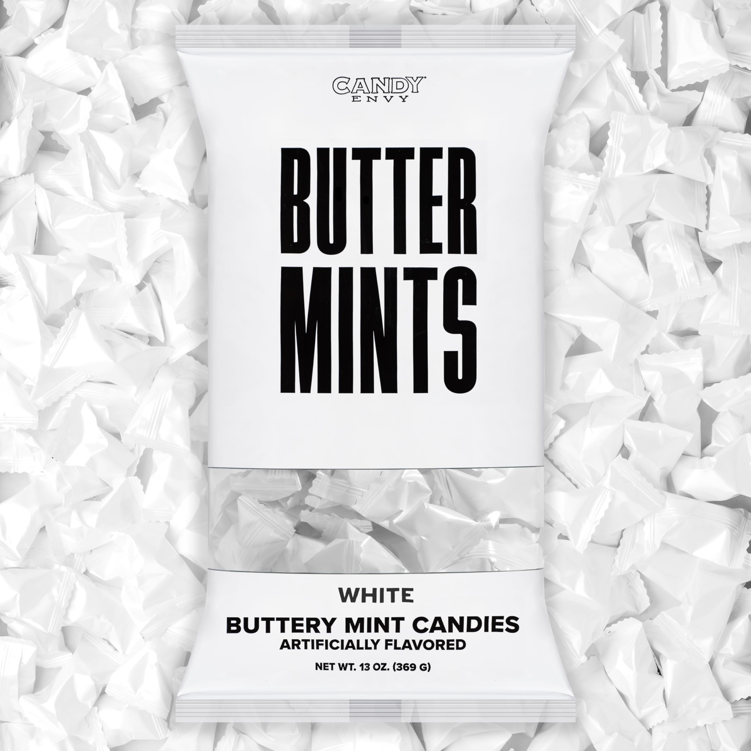 Candy Envy white-wrapped buttermints on a display tray, ideal for weddings.