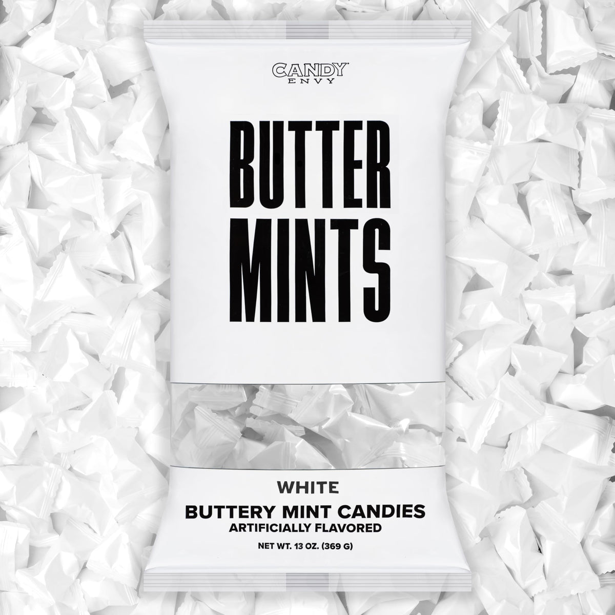 Candy Envy white-wrapped buttermints on a display tray, ideal for weddings.