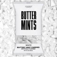 Candy Envy white-wrapped buttermints on a display tray, ideal for weddings.