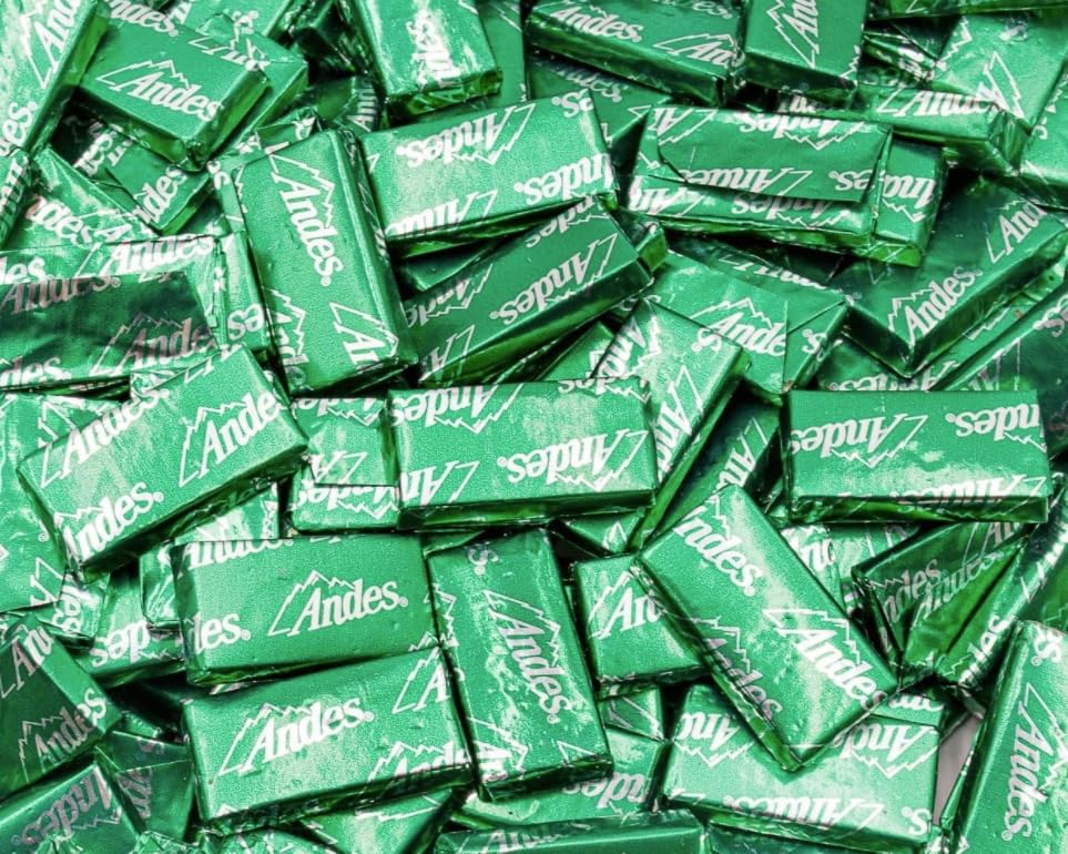Candy Retailer Crème de Menthe Mints chocolate layers close-up, highlighting smooth texture and mint center.