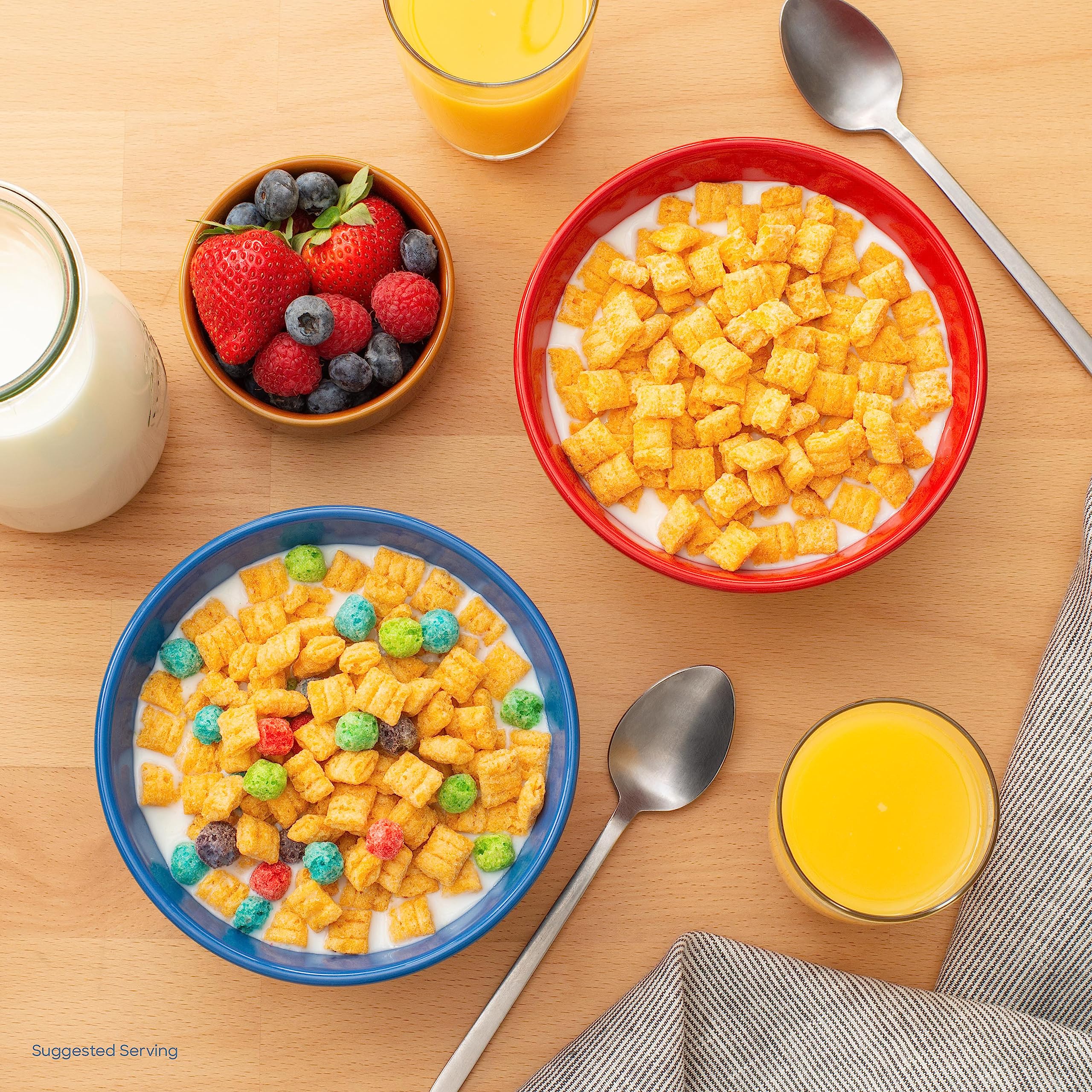 Cap'n Crunch Crunchberries cups served with spoon and milk.