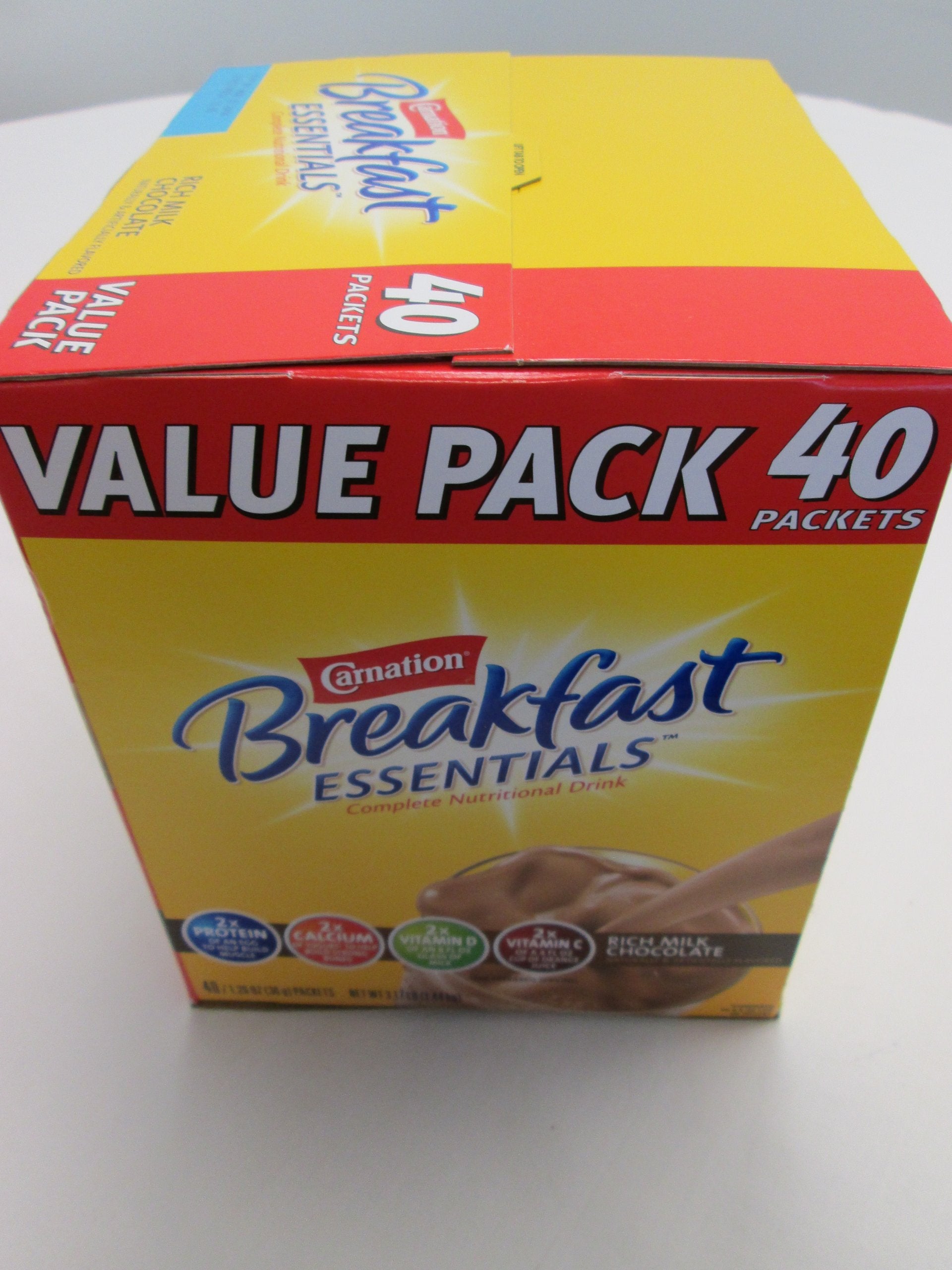 Carnation Breakfast Essentials Rich Milk Chocolate shake ready in a glass for energy.