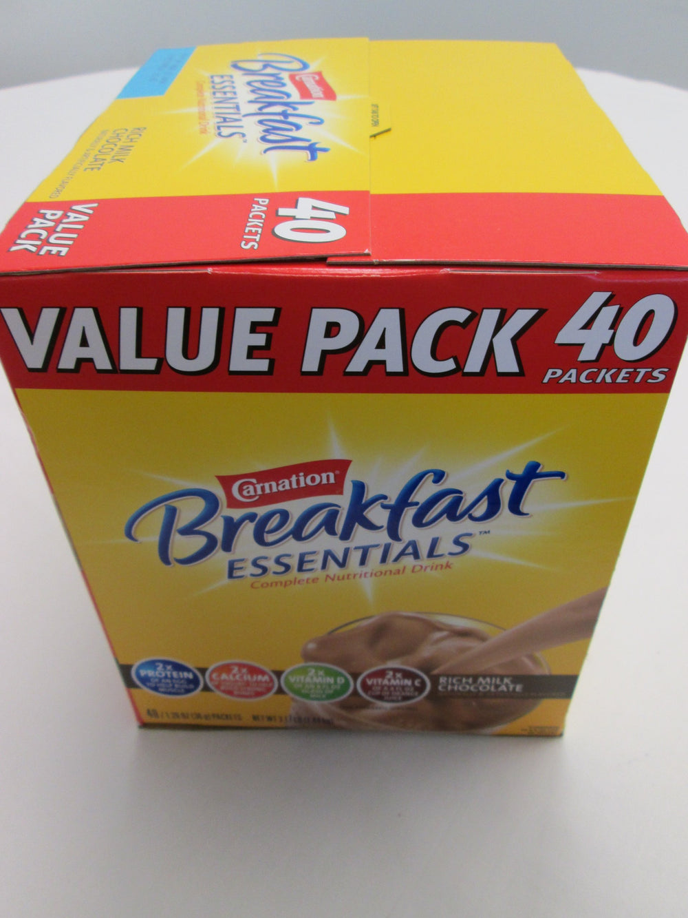 Carnation Breakfast Essentials Rich Milk Chocolate shake ready in a glass for energy.