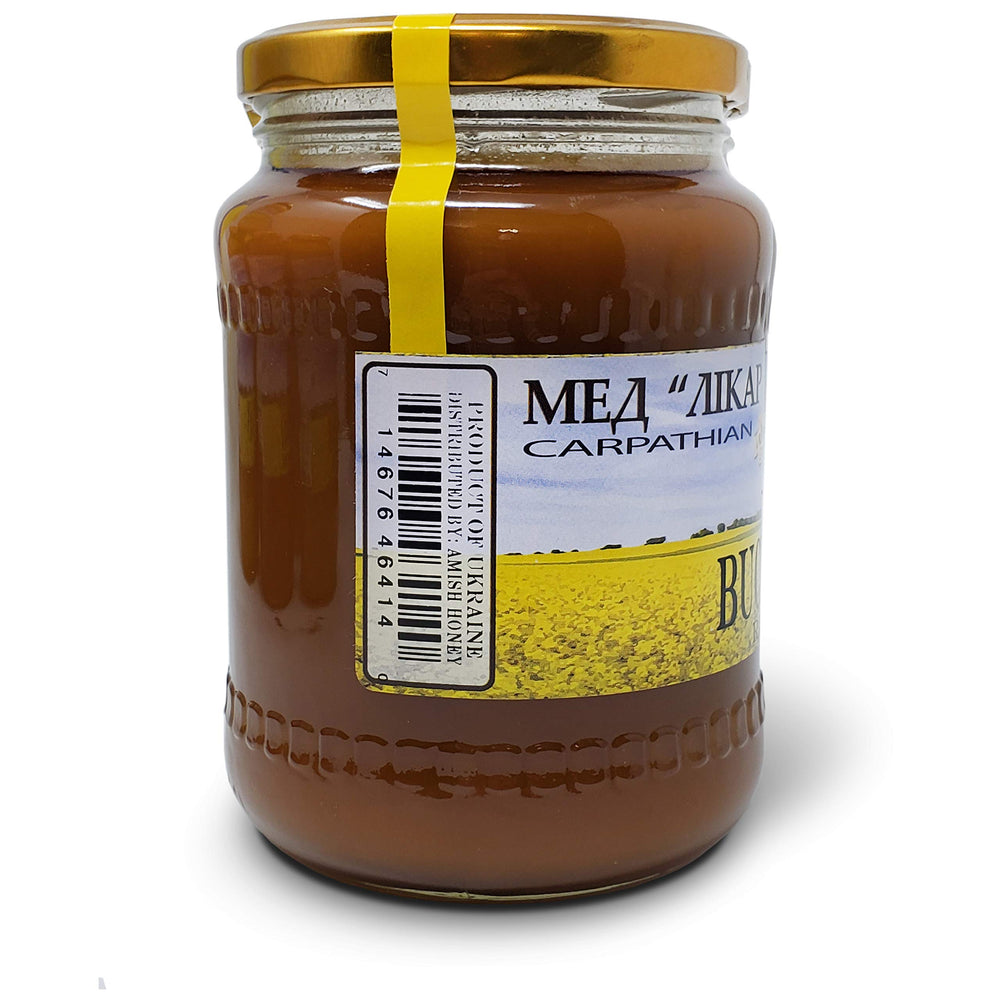 Carpathian Healer Buckwheat Honey mountains backdrop conveys pristine origin.
