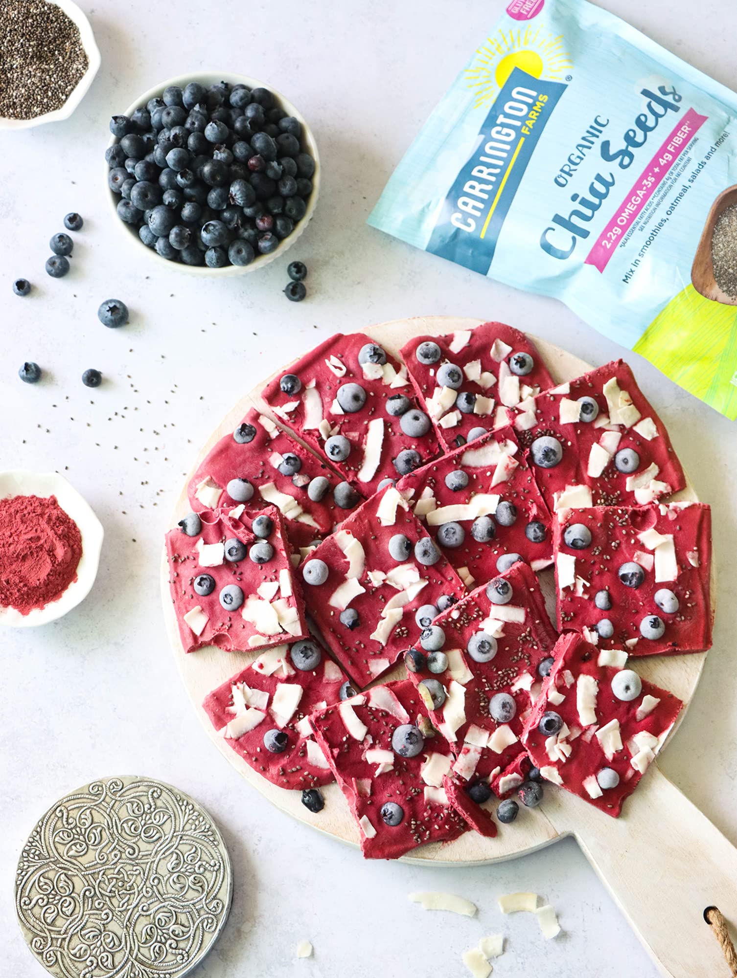 Chia seeds sprinkled on yogurt with Carrington Farms label.