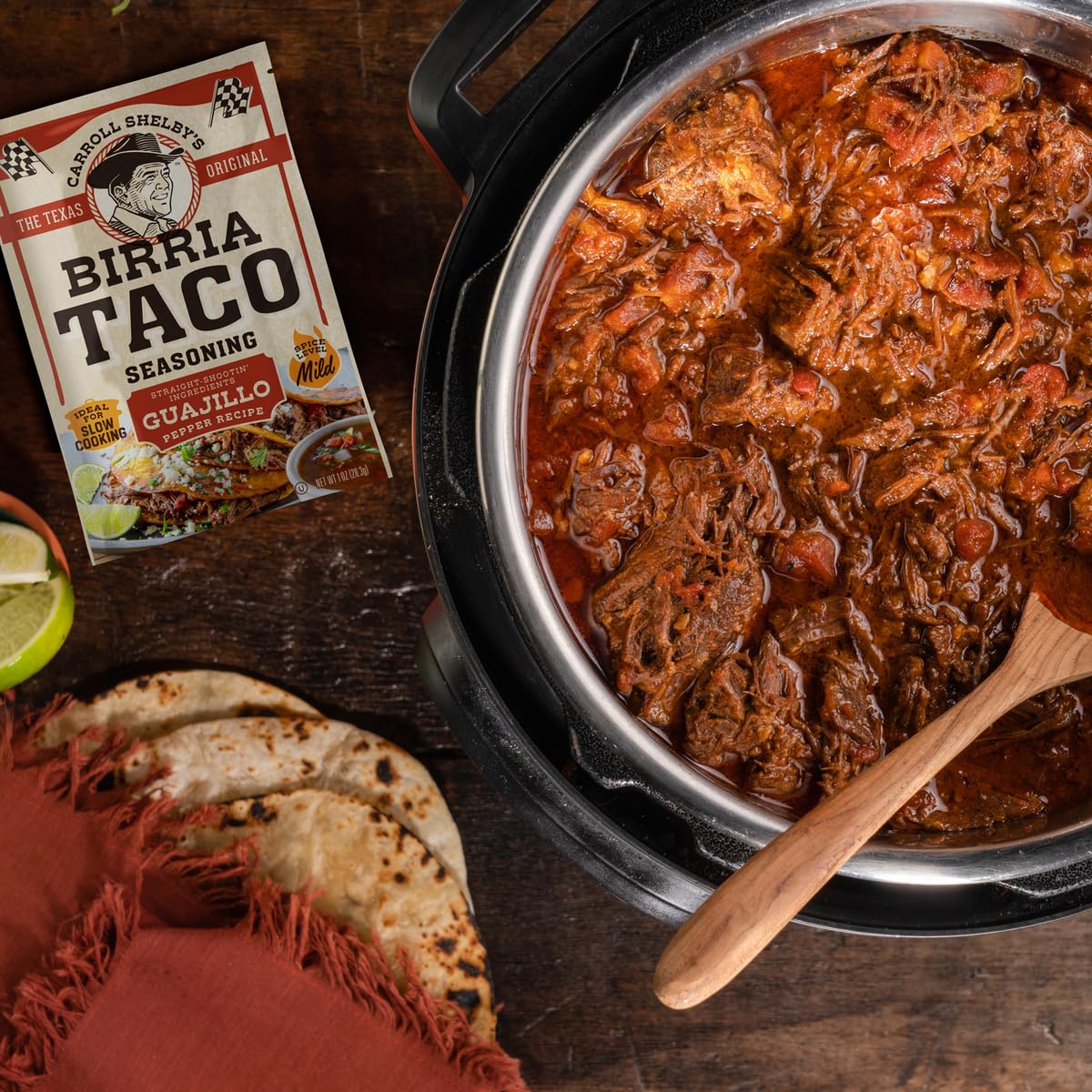 Whole guajillo peppers and spices beside Carroll Shelby's Birria seasoning