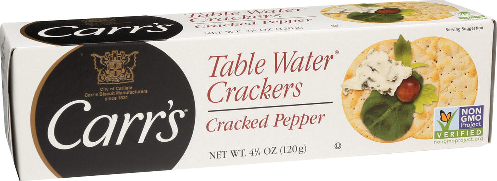Cracked pepper crackers beside grapes and honey on a serving board