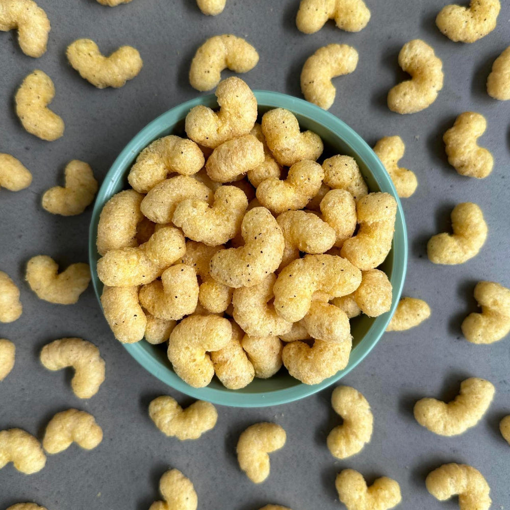 CauliPuffs cauliflower-based base emphasizes veggie-forward bite in a familiar puff snack.