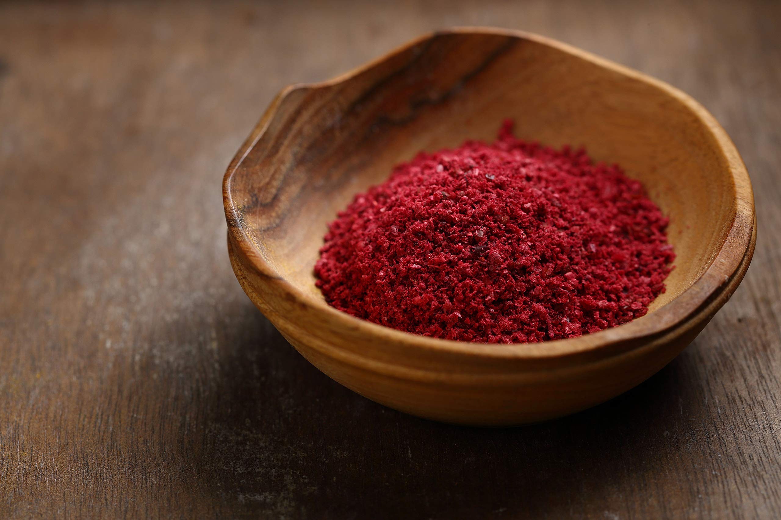 Cerez Pazari sumac spice powder close-up texture reveals fine, vibrant red-tan dust