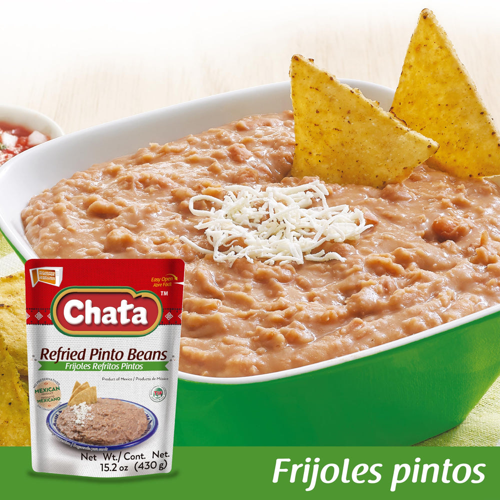 Chata refried pinto beans three-pack on kitchen counter, convenient pantry staple.