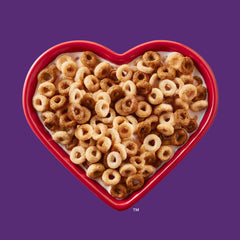 Pour Cheerios Multi Grain into a bowl, showcasing the crunchy texture.