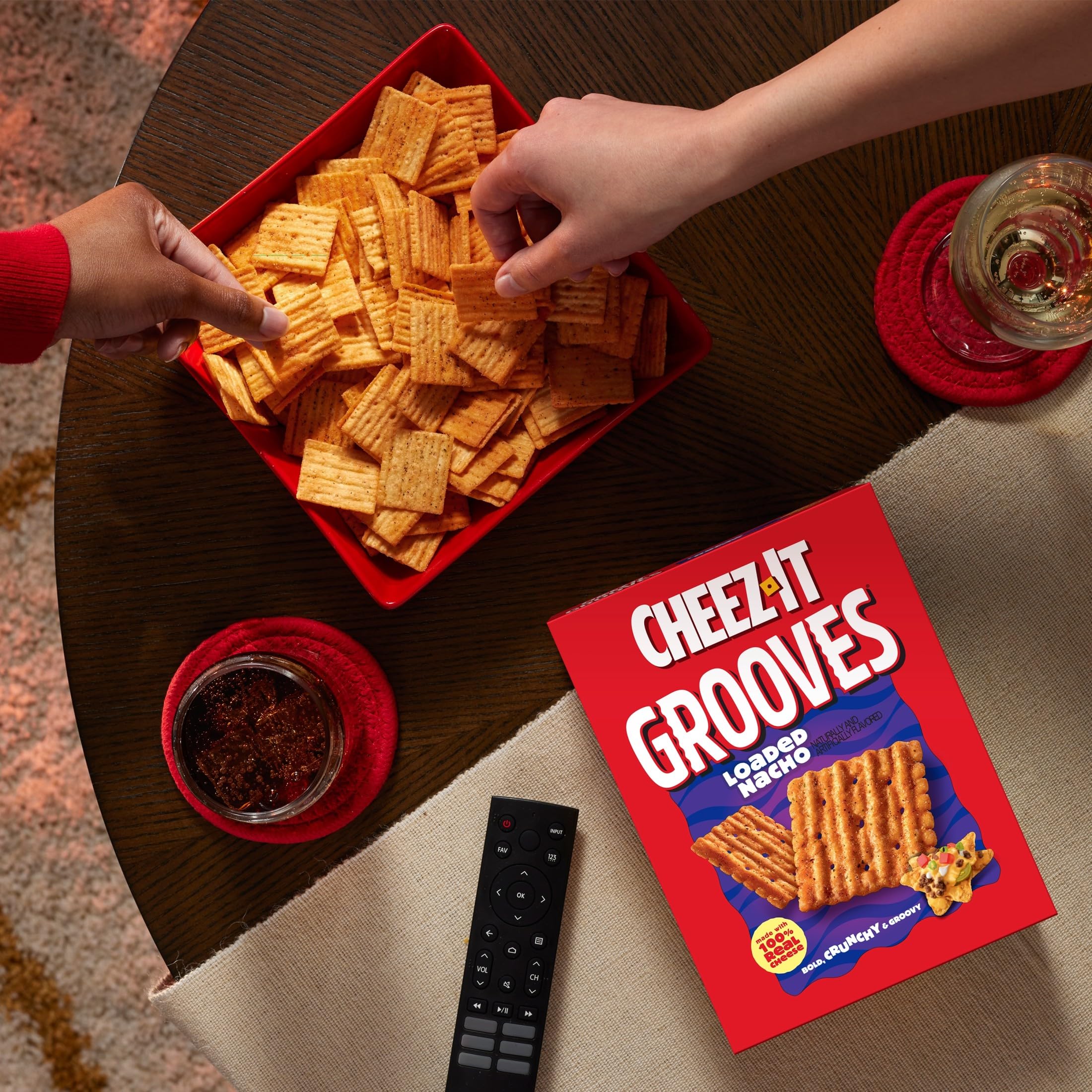 Cheez-It Grooves Loaded Nacho crackers on a car cup holder during a road trip.