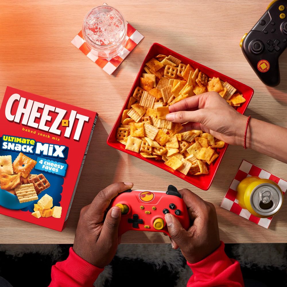 Pouring Cheez-It mix into a serving bowl for sharing