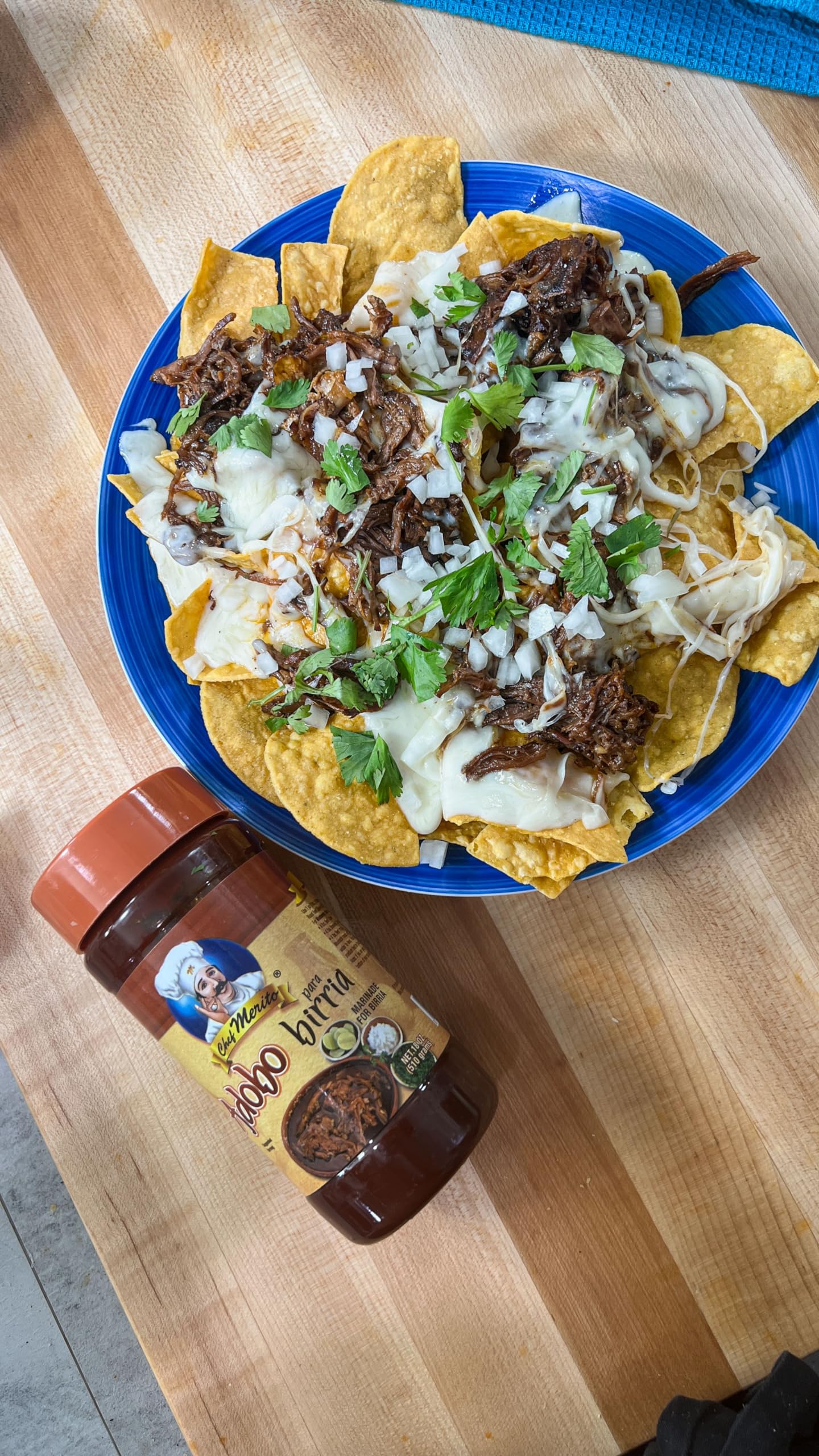 Chef Merito Birria Marinade simmer with broth suggesting rich depth of flavor.