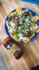 Chef Merito Birria Marinade simmer with broth suggesting rich depth of flavor.