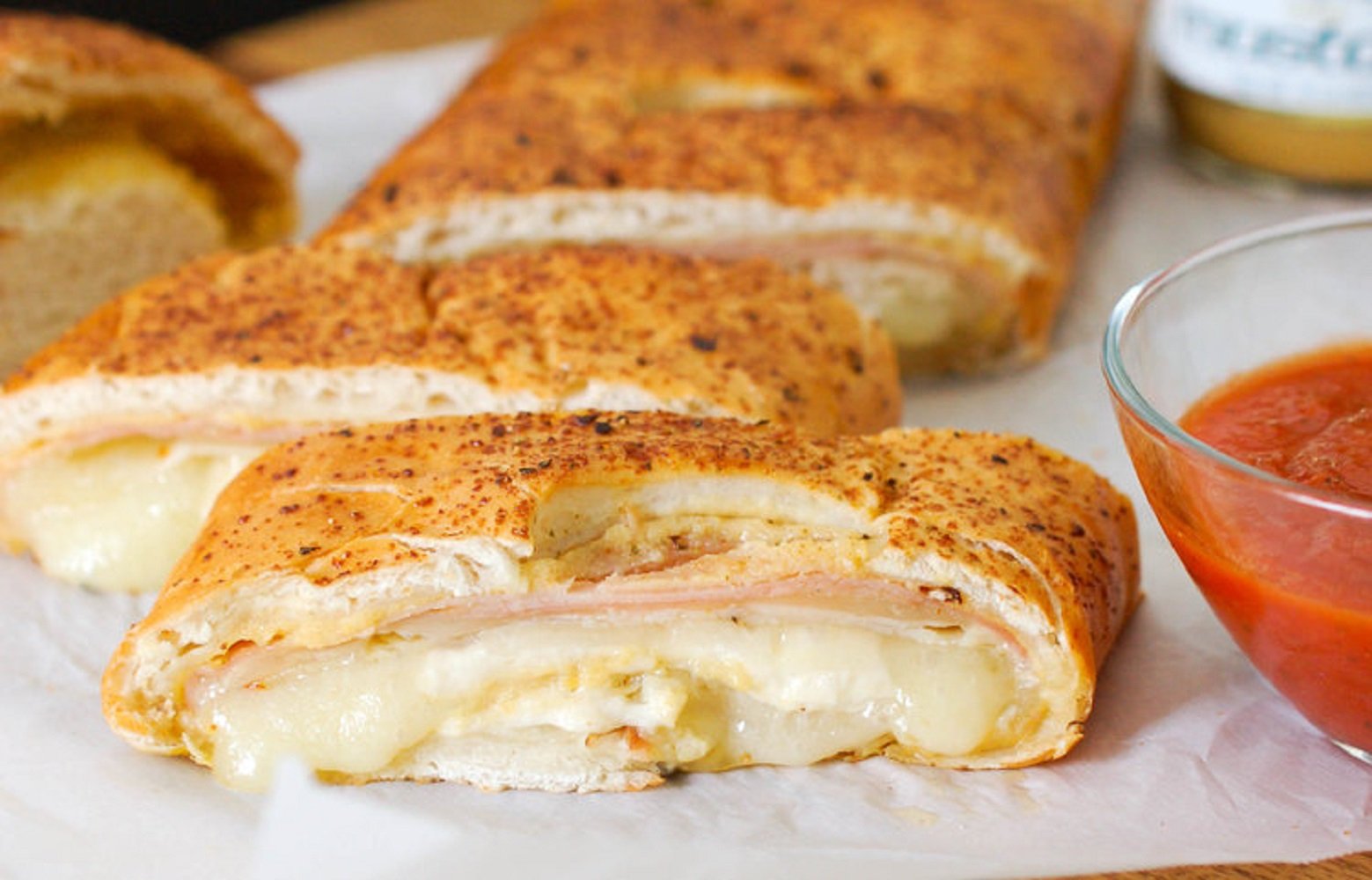 Sliced sandwich spread with Cherchies Champagne Mustard for a flavorful bite.