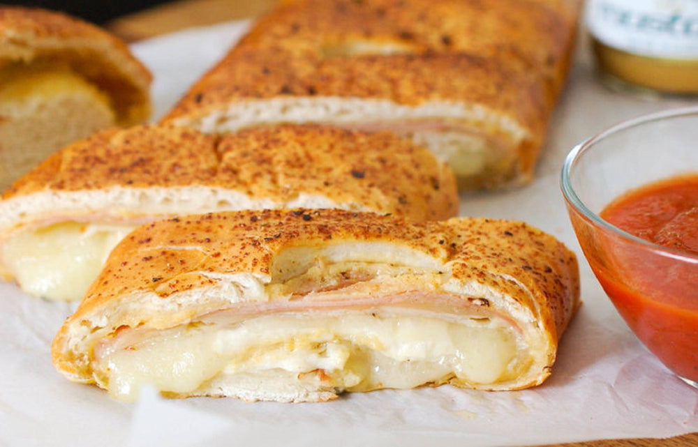 Sliced sandwich spread with Cherchies Champagne Mustard for a flavorful bite.