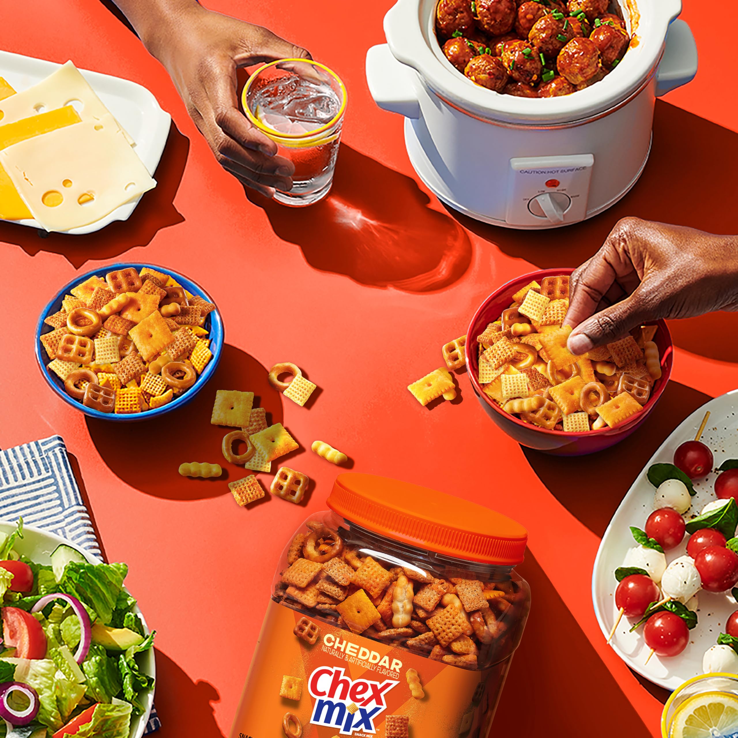 Chex Mix Cheddar tub on store shelf, a snack ready for grab-and-go.