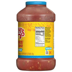 Pouring CHI-CHI’S Salsa Medium adds zesty heat to tacos and fajitas.